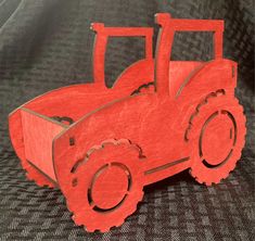 a red wooden model of a tractor