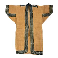 This 19th-century Ainu Attus (bark fiber) robe is a remarkable testament to the cultural heritage and resilience of the Ainu people. Crafted with meticulous care, it stands as an exceedingly rare and exceptional piece of Ainu craftsmanship. The foundation of this robe is woven from the fibers of elm bark, a material intrinsically linked to the Ainu's deep connection to the natural world. The indigo cotton embroidered trim adorning this Attus robe is a striking testament to their unique cultural Ainu People, Martial Arts Uniform, Cultural Artifact, Embroidered Trim, Japanese Textiles, Support Mural, Cultural Heritage, Custom Wall, Natural Fibers