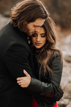 a young man and woman embracing each other