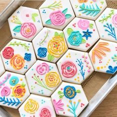 decorated sugar cookies arranged in the shape of hexagons with flowers on them