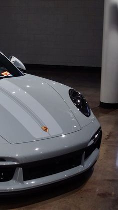 a white sports car parked in a garage