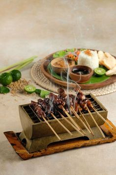 skewers of food sitting on top of a wooden tray