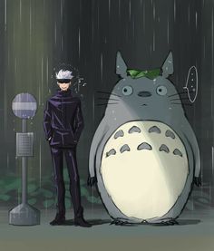 a man standing in front of a totoro and another person with an umbrella