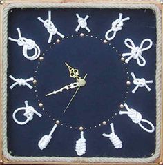 a clock made out of rope with scissors and other items on the face, sitting in front of a wooden frame