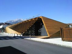 a wooden structure on the side of a road