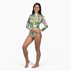 Stylish and protective, the Berry Jane Ruched Side Long Sleeve Swimsuit Rash Guard Set is perfect for active watersports. Fully lined with a built-in bra and removable pads. This beautiful Hawaiian floral print rash guard was made for days spent in the sun and at the beach. UPF 50 protection helps shield your skin from harmful rays, while the ruched sides provide a flattering fit. Whether you're hitting the beach or pool, this rash guard swimsuit is a must-have for your next adventure. Sale item Tropical Stretch Swimwear With Upf 50+, Fitted Rash Guard For Beach Vacation, Fitted White Rash Guard For Poolside, Fitted Green Rash Guard, Green Rash Guard For Poolside And Beach Season, Green Rash Guard For Swimming, Beach Season, Tropical Swimwear With Upf 50+, Tropical Swimwear With Upf 50+ For Swimming, Green Fitted Rash Guard For Beach Season