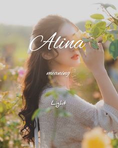 a woman holding flowers with the words aluna in front of her face and behind her head