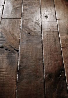 an old wooden floor with peeling paint on the top and bottom part of it's surface