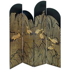 three panels with gold and black designs on the front, one is open to reveal an image of birds flying over waves