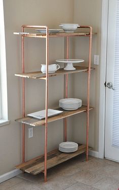 a wooden shelf with plates and bowls on it