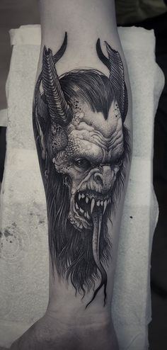 a man's leg with a demon tattoo on it