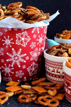 several bowls filled with pretzels and other snacks