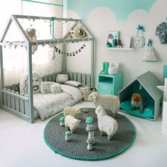 a child's bedroom decorated in white and green with sheep, dog house and bed