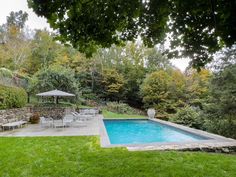 an outdoor pool surrounded by lush green grass