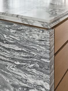 a marble counter top sitting on top of a wooden cabinet