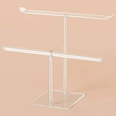 two clear acrylic stands with one standing and the other sitting on it's side