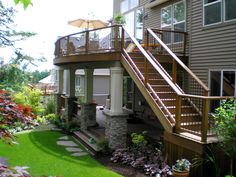 a house with a deck and stairs in the yard