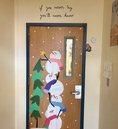 a door decorated with paper snowmen and trees