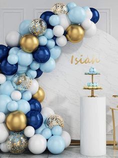 a balloon arch with blue, white and gold balloons