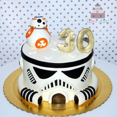 a star wars themed cake with a snowman and storm trooper decoration on the top