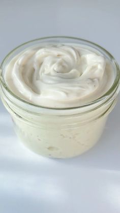 a jar filled with cream sitting on top of a table