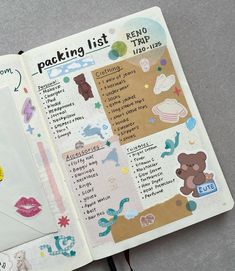 an open planner book with stickers on the pages and writing about packing list in it