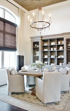 a dining room table with chairs and a chandelier