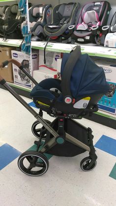 a baby stroller is on the floor in a store with other items behind it