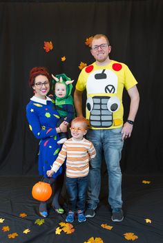 a man, woman and two children are dressed up in costumes