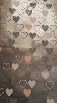 hearts are arranged in the shape of heart shapes on a silver background with pink and white confetti