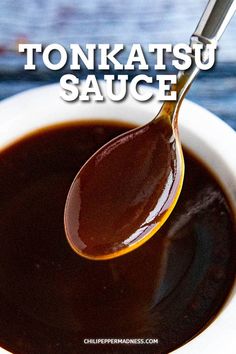 a spoon full of sauce with the words tonkatsu sauce on it and an image of