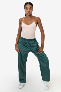 These Nylon Taffeta Track Pants feature an extra wide, baggy straight leg fit. They feature 2 side pockets, 1 back pocket and an elastic waistband with drawcord for an adjustable fit. We've lined these pants with a lightweight 100% combed cotton jersey for comfort and extra insulation. Made in Los Angeles, Calif. Our experienced sewers earn up to $25 an hour and no less than $16; additionally workers have healthcare benefits for less than $15 per week, a 401k plan, paid sick days, subsidized bus Blue Algae, Bus Pass, Pant For Women, Track Pant, Baggy Fits, Combed Cotton, Fashion Pants, Track Pants, Harem Pants