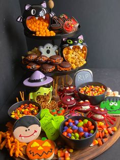 a table topped with lots of halloween treats and candies on top of each other