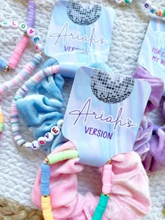 several hair ties laying on top of a white blanket next to beads and bracelets