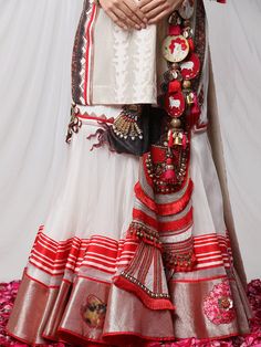 Garad Angrakha Lehenga - Inspired by gauri(durga), this lehanga set brings elements of akalbodhan, translating to the untimely awakening of Durga. The set features a gota bralette, an angrakha jacket and a full-pleated skirt, making it a perfect royal garment for your special occasions. Transitional Pre-draped Saree With Cutdana For Traditional Ceremonies, Ceremonial Pre-draped Saree With Cutdana, Traditional Pre-draped Saree With Sheer Dupatta For Navratri, Bohemian Pre-draped Saree With Motifs For Navratri, White Choli With Sheer Dupatta For Transitional Season, Bohemian Chanderi Sets With Cutdana Details, Traditional Ceremonial Pre-draped Saree With Cutdana, White Pre-draped Saree With Gota Work For Navratri, Unstitched Lehenga For Festive Transitional Season