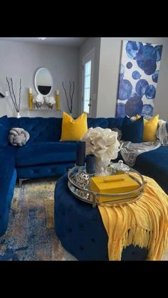 a living room filled with blue couches and yellow pillows