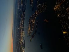 an aerial view of the city lights at night taken from an airplane window in flight