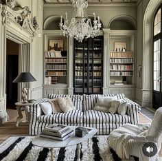 a living room filled with furniture and a chandelier