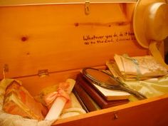 an open wooden box filled with books and other items