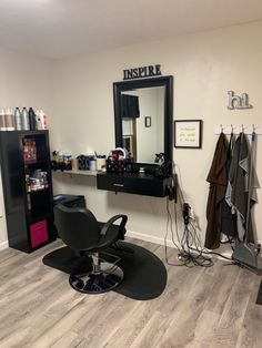 a room with a chair, mirror and hair dryer