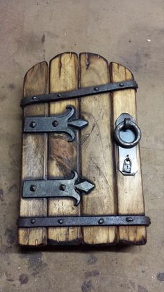 a wooden box with metal handles and latches on it's sides, sitting on the ground