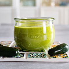 a green smoothie in a jar with cucumbers