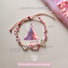 the pink butterfly princess bracelet is next to some candy candies and a plastic box