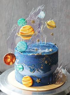 a blue cake with planets and stars on it