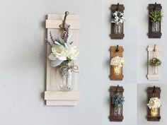 several vases with flowers are hanging on the wall next to wooden plaques and lights