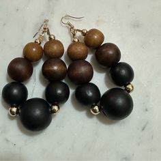 Beautiful Wood Bead Earrings With Gold Spacer Beads Fish Hook Style Measures 4” Long Elegant Beaded Earrings With Colorful Beads, Elegant Brown Beaded Earrings With Colorful Beads, Adjustable Brown Beaded Earrings With Large Beads, Black Beaded Drop Earrings With Large Beads, Brown Beaded Hoop Earrings As Gift, Black Large Beaded Drop Earrings, Brown Dangle Jewelry With Black Beads, Black Earrings With Large Round Beads, Brown Earrings With Dangling Round Beads