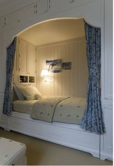 an image of a bed in a room with curtains on the windows and lights on