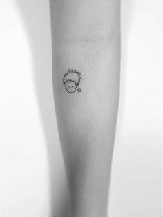 a black and white photo of a person's leg with a small tattoo on it