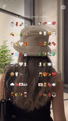 the back of a woman's head with many stickers on her hat and hair