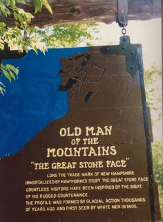 an old man of the mountains sign hanging from a tree